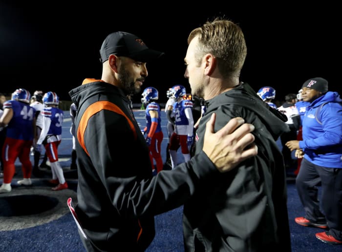 Pittsburg coach Charlie Ramirez (left) and Folsom coach Paul Doherty greet near midfield after Saturday's 28-25 Folsom victory.